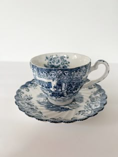 a blue and white tea cup on a saucer