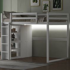 a white loft bed with a desk underneath it and shelves below the bed for storage