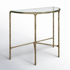 a glass and gold metal table with a curved top on an isolated white background,