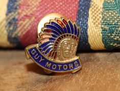 a close up of a badge on a wooden surface near a colorful pillow and rug