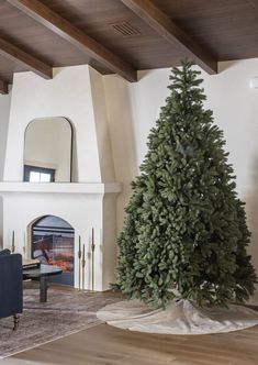 a living room with a christmas tree in the middle