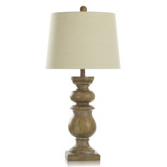 a wooden table lamp with a white shade on the base and a beige linen lampshade