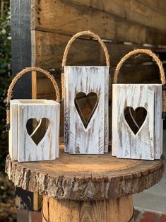 three small wooden bags with hearts on them