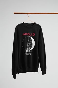 a black sweatshirt hanging on a clothes line with the words,'apollo nasa '