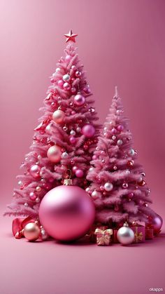 a pink christmas tree with ornaments on it