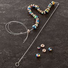 the beaded necklace is laying on the table next to it's earwires