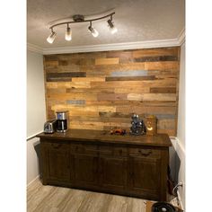 a kitchen with wood paneling on the wall