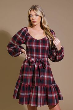 A woven plaid mini dress featuring sweetheart neckline, smocked bodice, long sleeve, self sash tie and ruffled hemline Details: Self : 50% Polyester 50% Cotton Size & Fit - Model is 5`8" And Wearing Size Small- Measurements Taken From Size Small- Approx. Length: 34" Plaid Mini Dress With Lining, Cotton V-neck Plaid Dress For Picnics, Cotton Plaid Mini Dress, Red Plaid Flannel Dress, Plaid Cotton Knee-length Mini Dress, Plaid Mini Dress, Flying Tomato, Girls Outerwear, Boys Pajamas