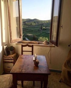 a wooden table sitting in front of a window