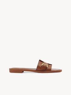 Chloé Marcie Slide | Chloé US Luxury Calf Leather Slides With Buckle Closure, Designer Leather Sandals With Gold Buckle, Classic Slides With Removable Insole, Classic Slip-on Sandals With Tang Buckle, Classic Sandals With Tang Buckle In Calf Leather, Luxury Leather Slides With Tang Buckle, Luxury Leather Sandals With Gold Buckle, Elegant Leather Slides With Buckle Closure, Luxury Slide Mules With Leather Footbed