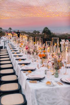 a long table is set up with plates and place settings