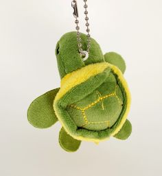 a stuffed turtle keychain hanging from a chain