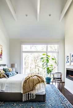 a bedroom with a large bed and fireplace