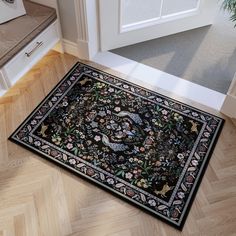 a large rug on the floor in front of a door with an ornate border around it