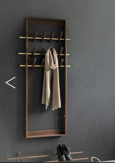 a coat rack with shoes and scarves hanging on it