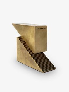 a golden box with stairs on the bottom is shown in front of a white background