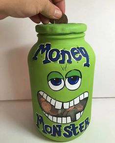 a green jar with an image of a monster on it that says money mon - step