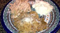 a blue and white plate filled with food on top of a table