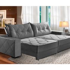 a gray couch sitting on top of a wooden floor