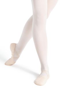 the legs of a ballerina in white tights