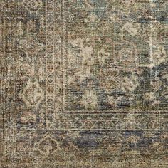 an old, faded rug with many different colors and patterns on the carpet is shown