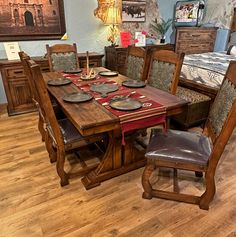 a dining room table with place settings on it