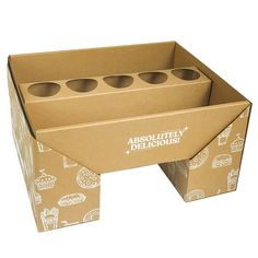 an open cardboard box with six donuts on the bottom and four holes in the middle