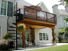 a house with a deck and stairs leading up to the front door