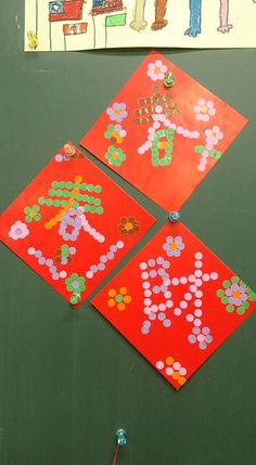 three pieces of red paper that have been made to look like children's artwork