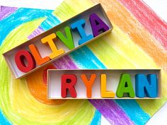 two wooden letters that spell out the word olitta and ryan on top of each other