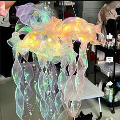 a chandelier made out of plastic and lights