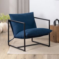 a blue chair sitting on top of a wooden floor