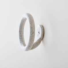 a pair of white rings mounted to the side of a wall