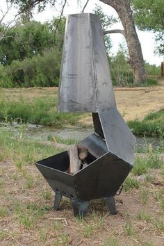 a metal sculpture sitting in the middle of a field