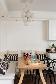 a wooden table sitting under a light fixture