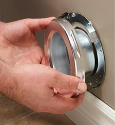 a man is adjusting the knob on a wall