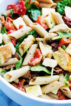 a bowl filled with pasta salad on top of a blue table