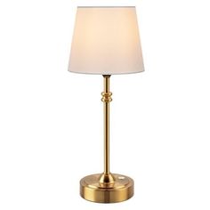 a gold lamp with a white shade on it