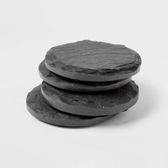 three black stone coasters stacked on top of each other