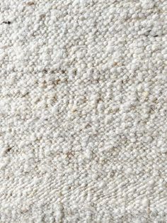 a close up view of the texture of a white carpet