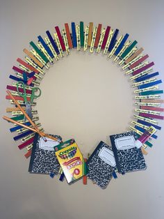 a wreath made out of school supplies and scissors