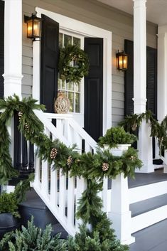 christmas wreaths and pine cones on the front porch