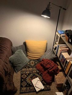 a living room filled with furniture and bookshelves next to a wall mounted lamp