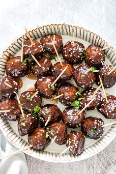 chocolate covered meatballs with toothpicks on a plate