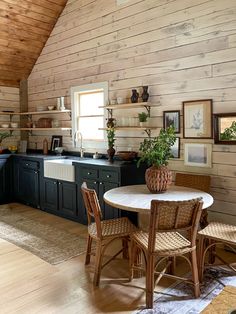 a table and chairs in a room with wooden walls