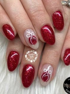 red and white manies with bows on the tip of each nail are decorated with glitter