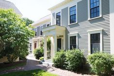 two story house with white trim and blue siding