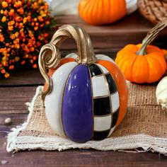 a decorative pumpkin sitting on top of a wooden table