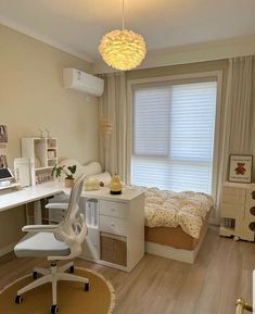 a bedroom with a bed, desk and chair in the corner next to a window