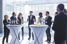 a group of people standing in front of a table with wine glasses on it and the words senior event planner job opening for laurder